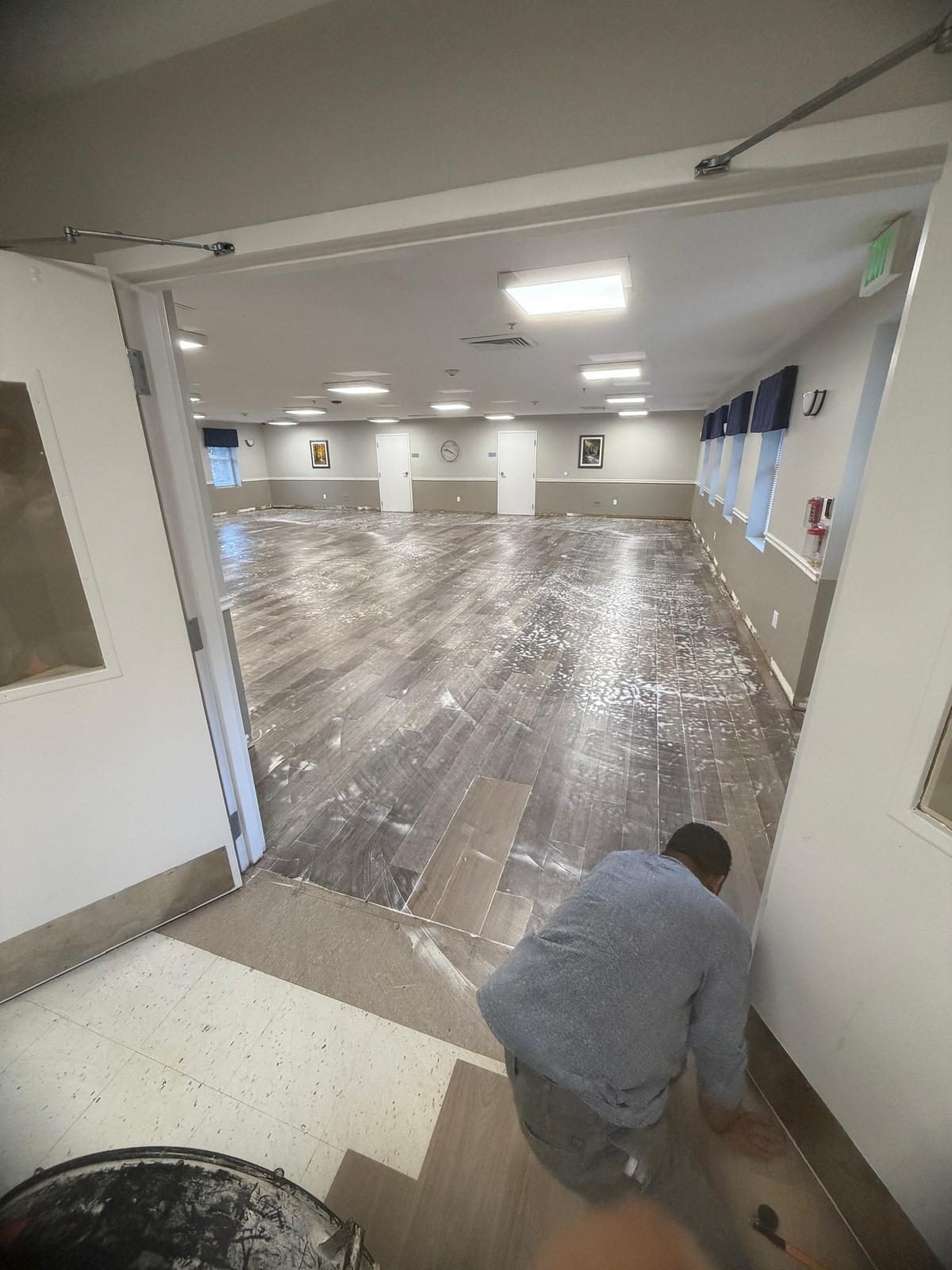 Commercial hall flooring installation in progress