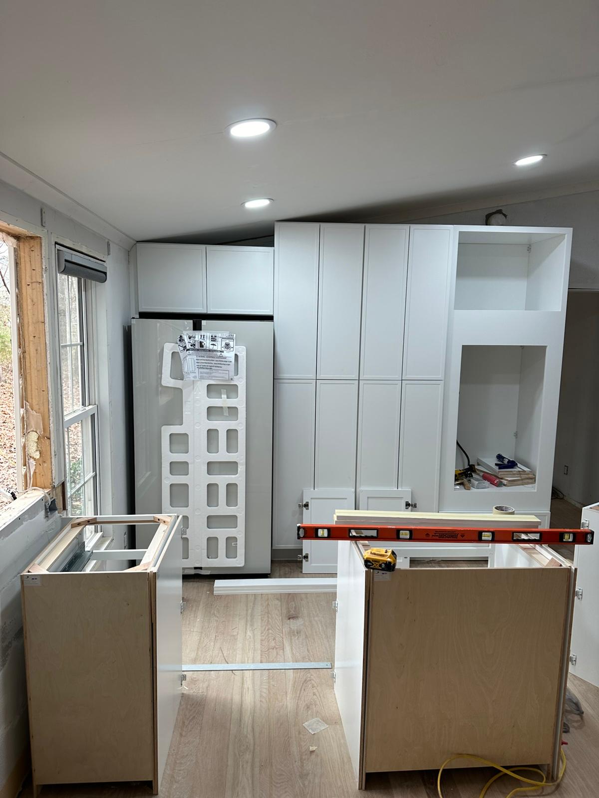 Custom white cabinetry framing during kitchen remodel