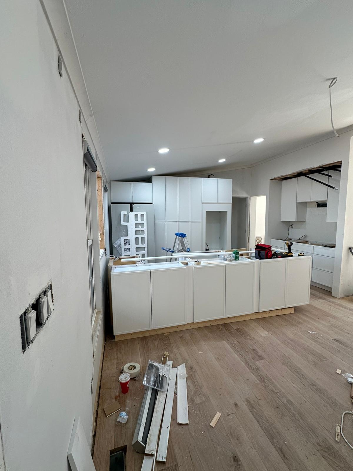 Kitchen remodel nearing completion with island and cabinetry