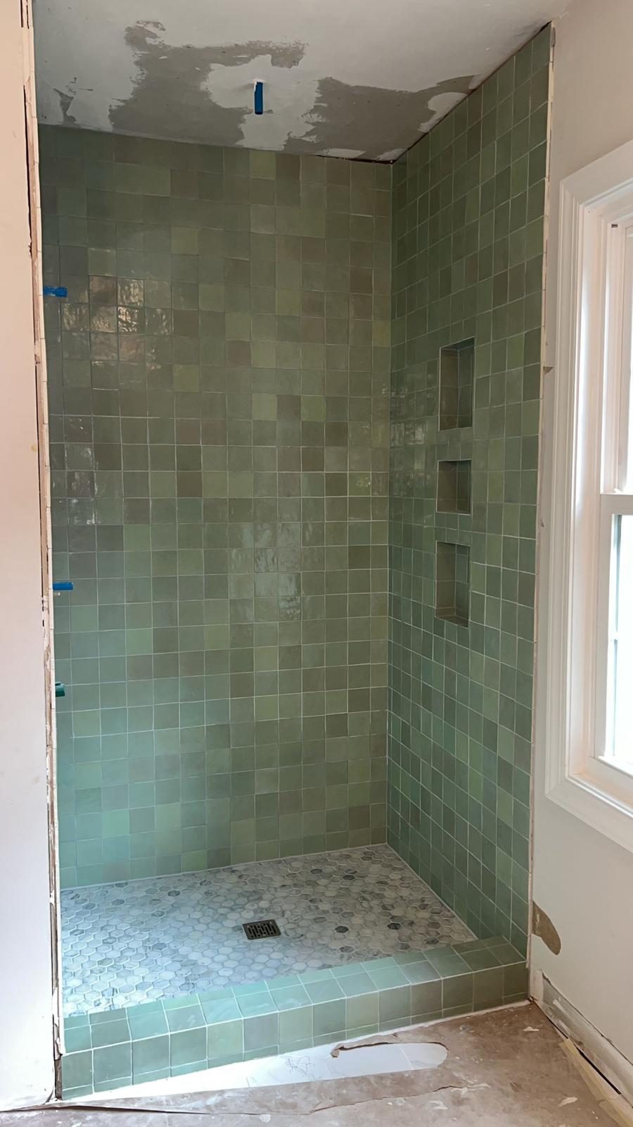 Green square shower tile with built-in niche shelves